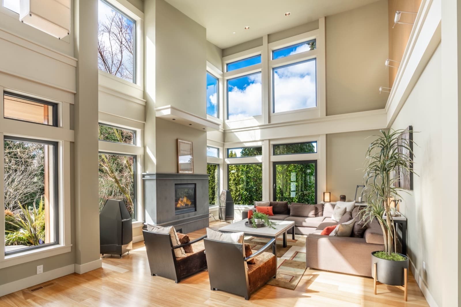 An open-plan living room with high ceilings and large windows