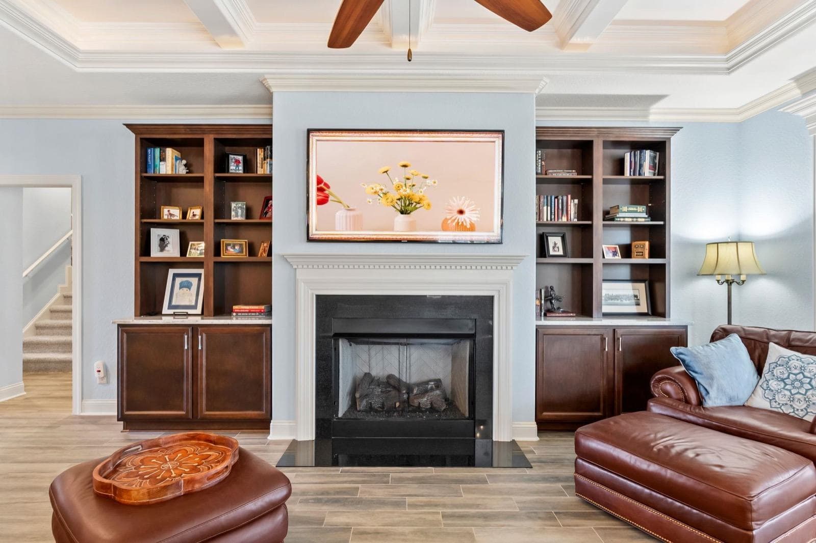 A staged living room with built-in bookcases either side of the fireplace at 750 Villarosa Dr., Grande Dunes, one of Robin's listings