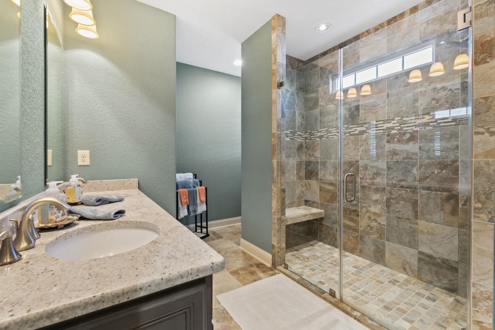 A tiled walk-in shower and vanity in one of Robin's listings