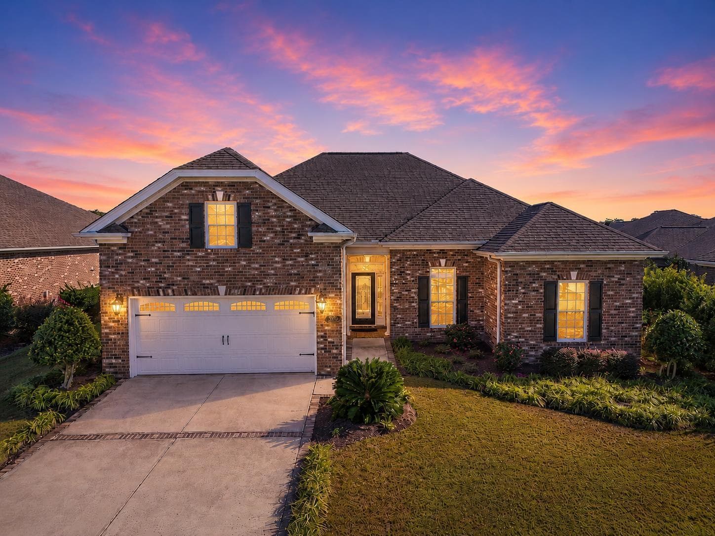 Twilight exterior of an all-brick home in Grande Dunes, one of Robin's listings