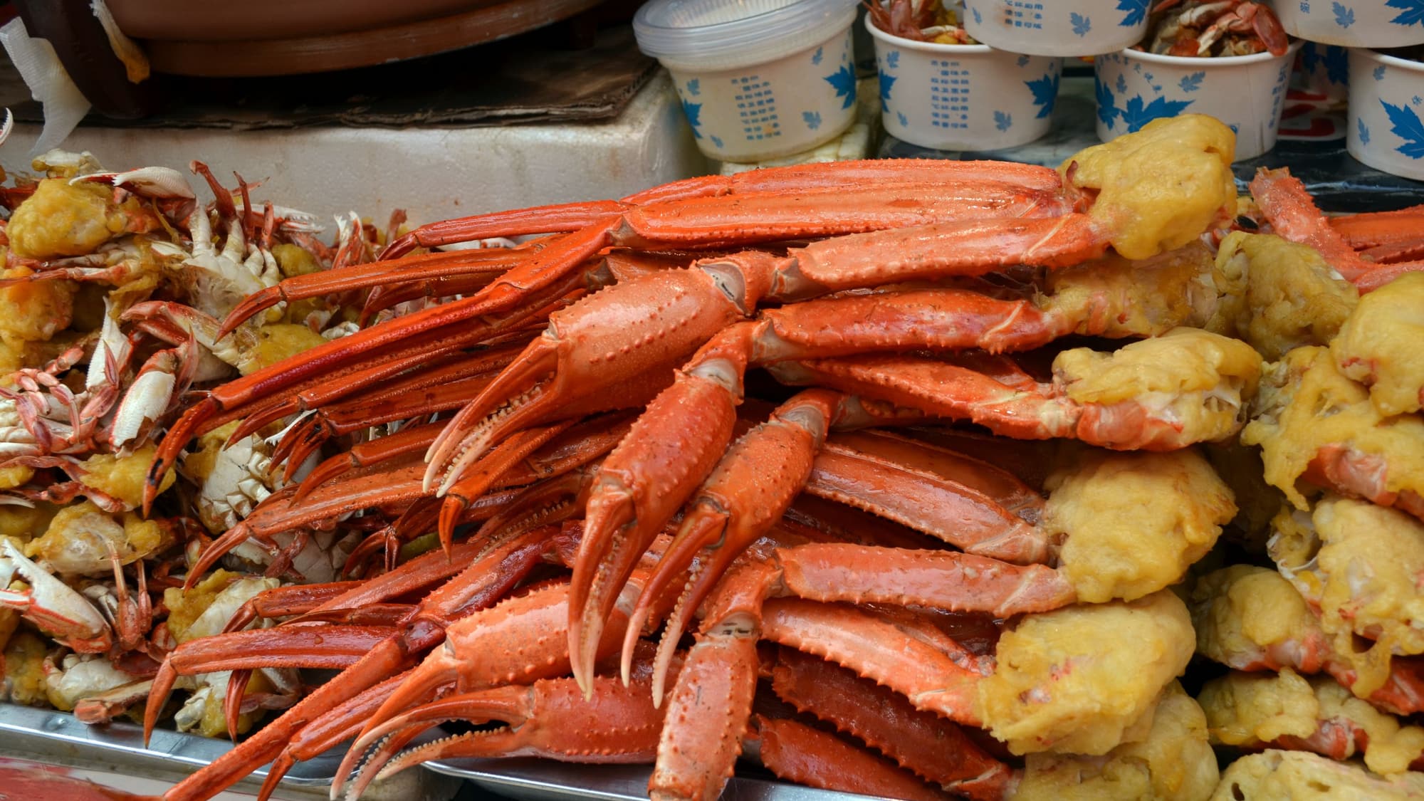 Cooked snow crab clusters piled high with corn and potatoes